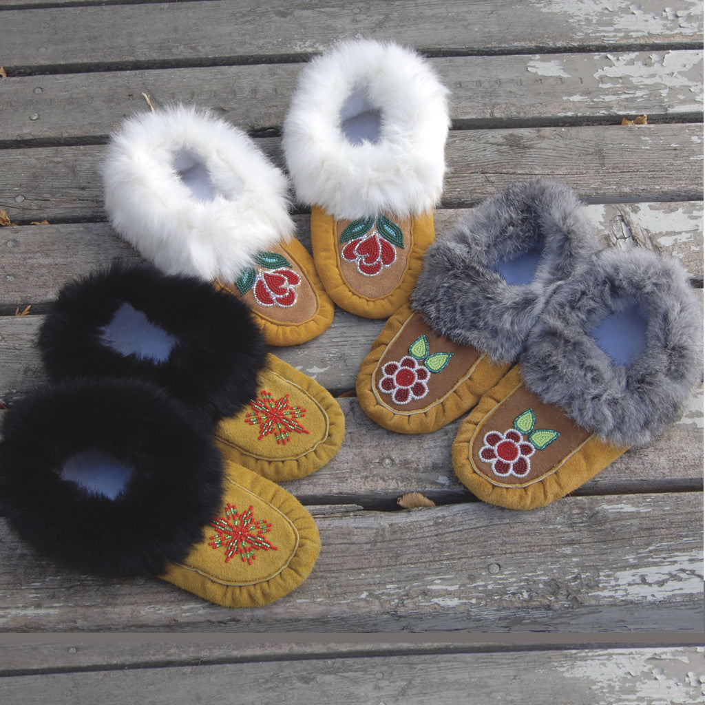 Deluxe Handmade Moccasins 3 pairs wooden background